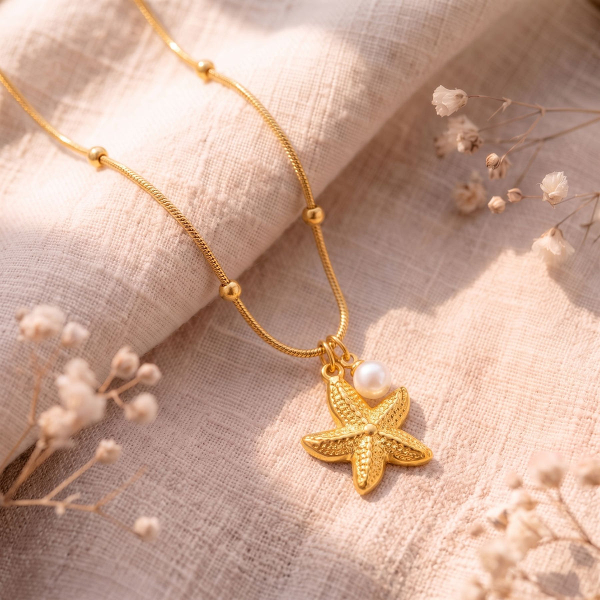 Women's marine necklace in gold stainless steel, starfish and white pearl in an elegant style