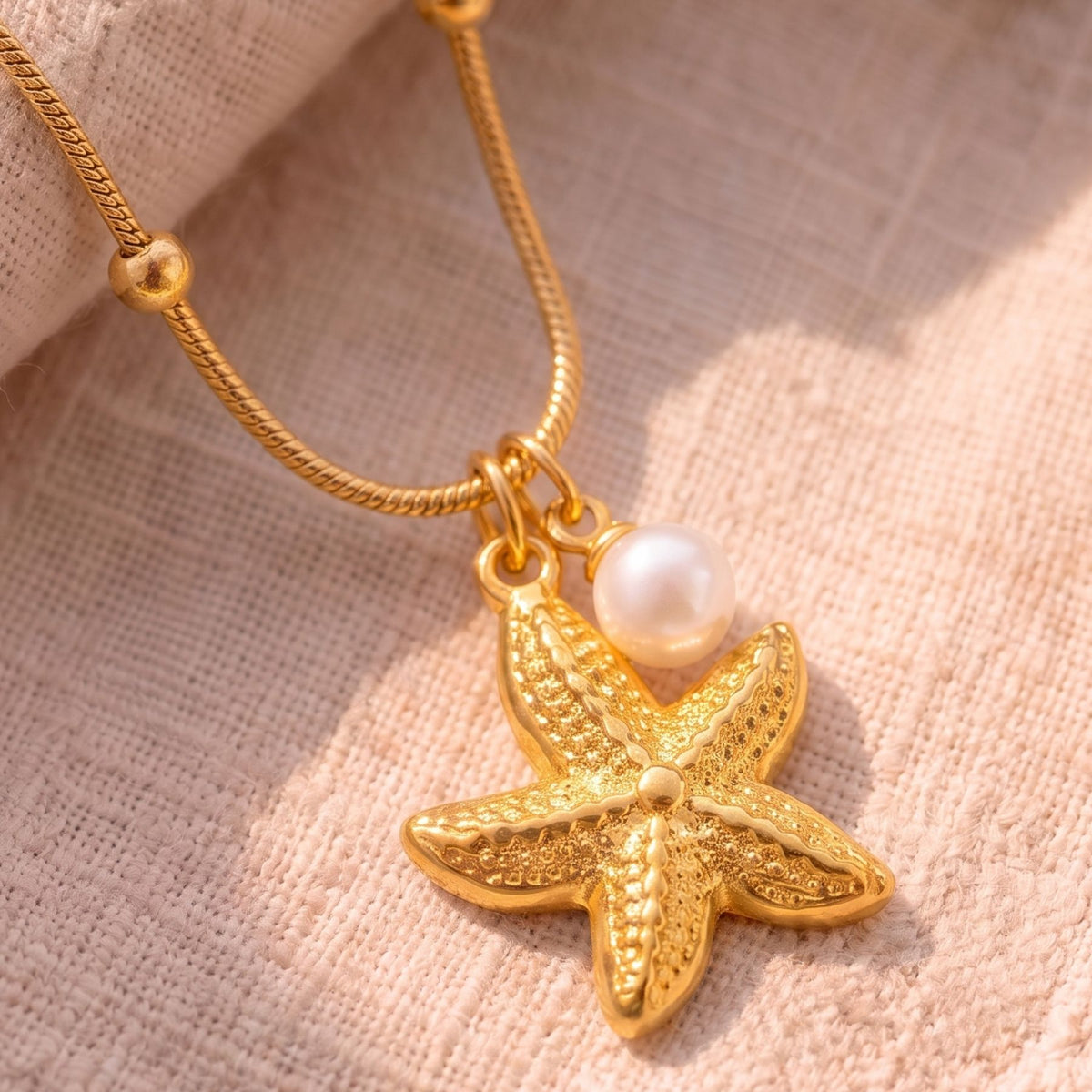 Women's marine necklace in gold stainless steel, starfish and white pearl in an elegant style