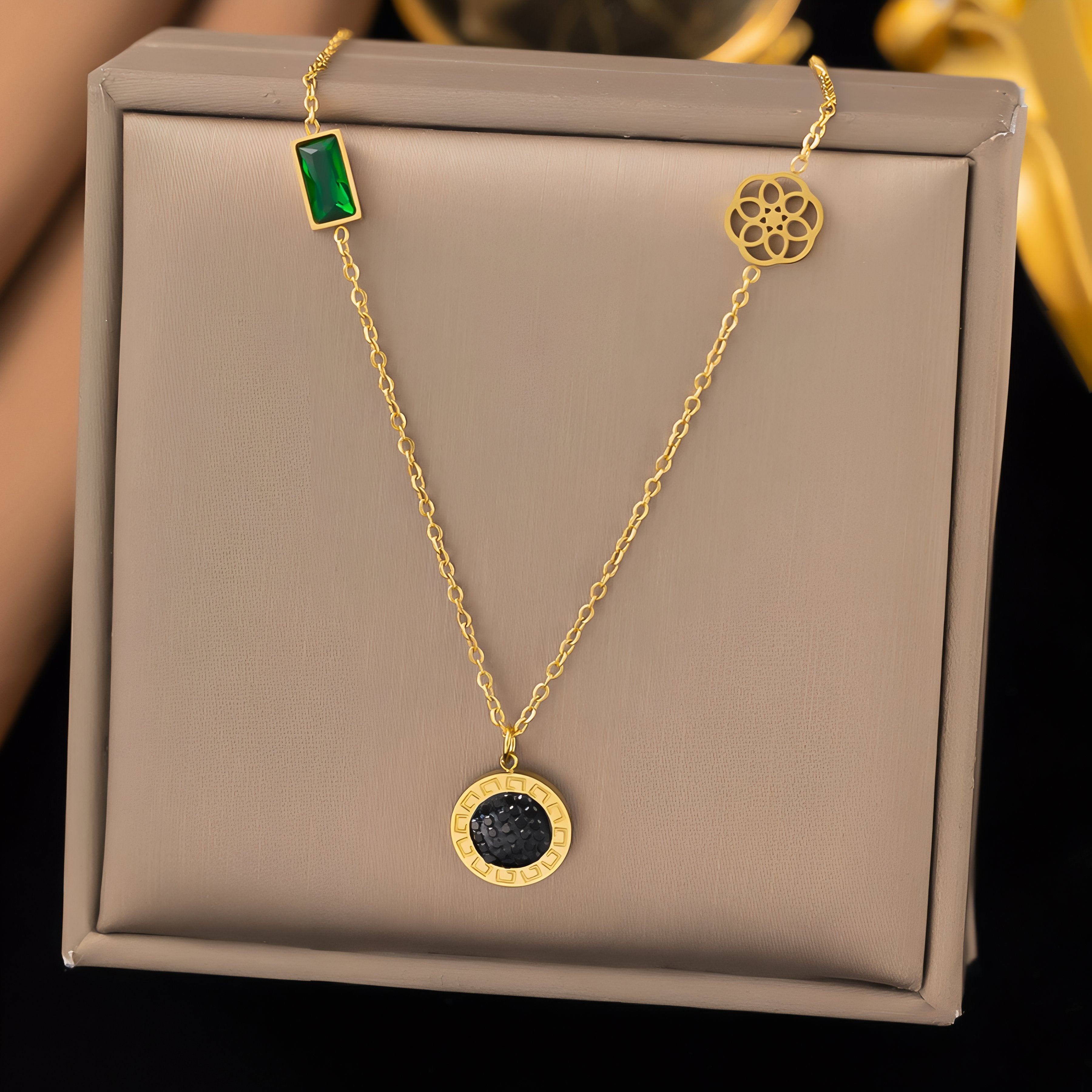 Women's pendant necklace with black rhinestone medallion and green glass, made of stainless steel