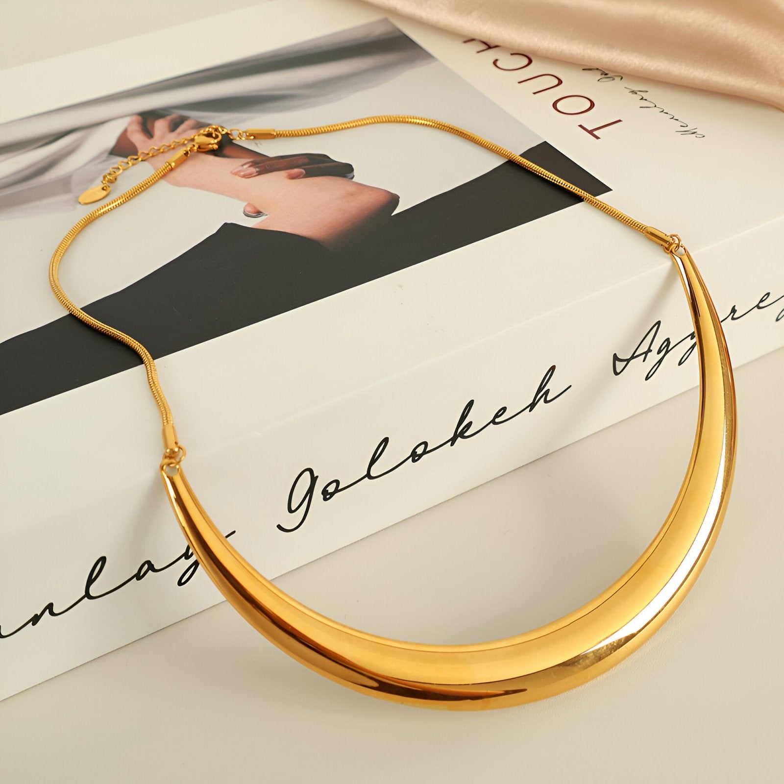 Collier plastron rigide pour femme, design incurvé doré ou argenté, style sculptural et moderne, modèle Alma